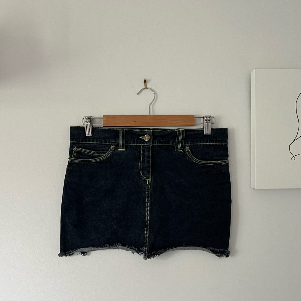 Y2K inspired dark wash denim mini skirt with contrast green stitching